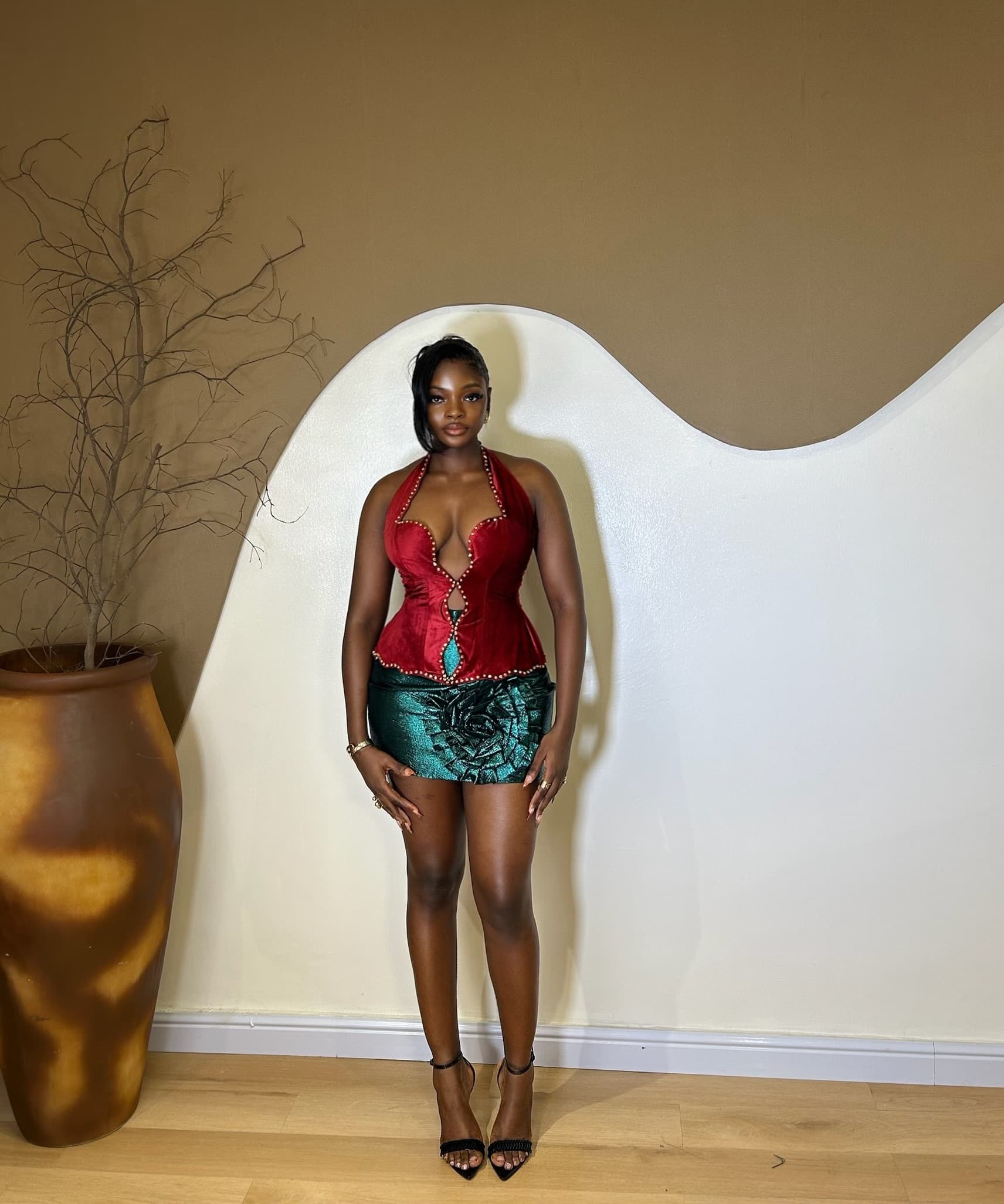 Full front view of the Rubi Set with a burgundy velvet halter top and emerald-green mini skirt.